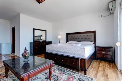 a bedroom with a bed and a coffee table at Vera Apartments in Ulcinj