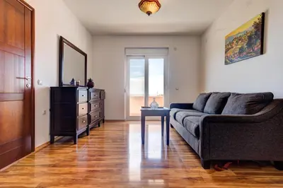 a living room with a couch and a dresser at Vera Apartments in Ulcinj
