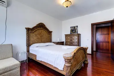 a bedroom with a large bed and a couch at Vera Apartments in Ulcinj