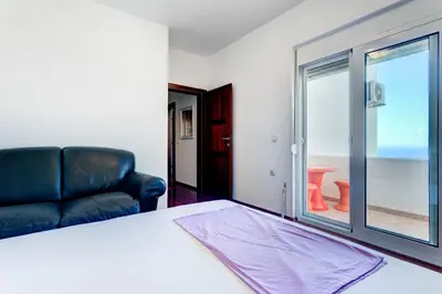 a room with a bed and a couch and a window at Vera Apartments in Ulcinj