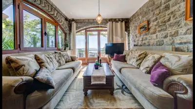 a living room with a couch and a table at Holiday Homes Sunset Hill in Sveti Stefan