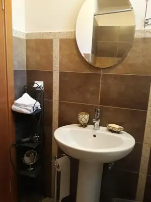 a bathroom with a sink and a mirror at Holiday Homes Sunset Hill in Sveti Stefan