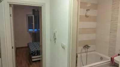 a bathroom with a shower and a tub and a sink at Guest House Mikeli (BESPL. DORUCAK)-(FREE BREAKFAST) in Podgorica