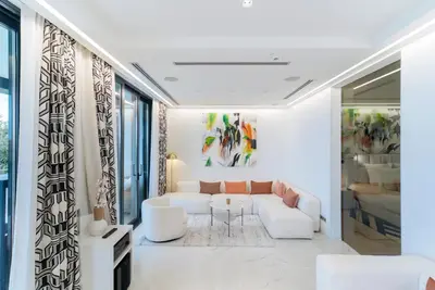 a living room with a white couch and a table at Villa Geba Boutique Hotel in Sveti Stefan
