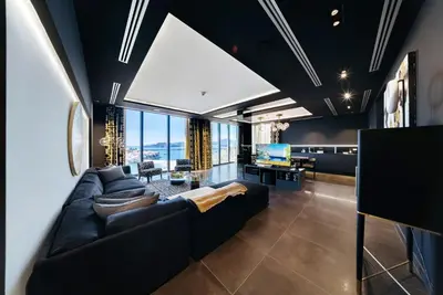 a living room with a couch and a tv at Villa Geba Boutique Hotel in Sveti Stefan