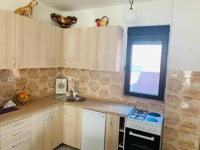 a kitchen with a stove and a sink and a window at Gara 5 in Kotor
