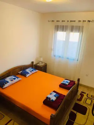 a bedroom with two beds and a window at Gara 5 in Kotor