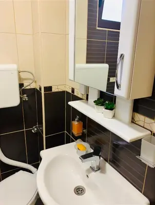a bathroom with a white sink and a mirror at Gara 5 in Kotor