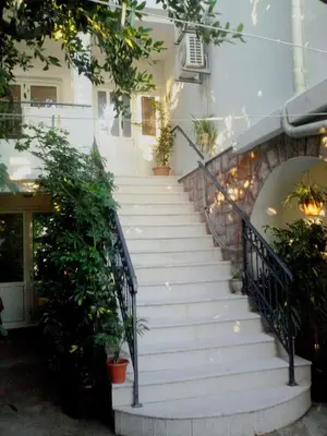 a staircase leading up to a house with potted plants at Oaza Guest House in Sveti Stefan