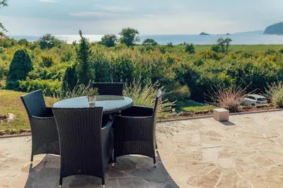 a table and chairs on a patio with a view at MonteBay villa in Budva
