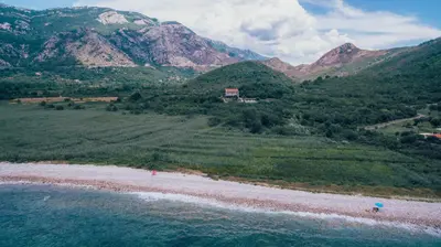 an aerial view of a beach with mountains in the background at MonteBay villa in Budva