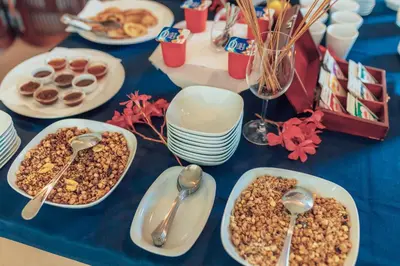 a table with plates of food and spoons on it at MonteBay villa in Budva