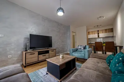a living room with a couch and a flat screen tv at Apartments Centrale 28 in Podgorica