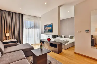 a living room with a bed and a couch at Adriatic Dream - Sea View Apartments in Budva