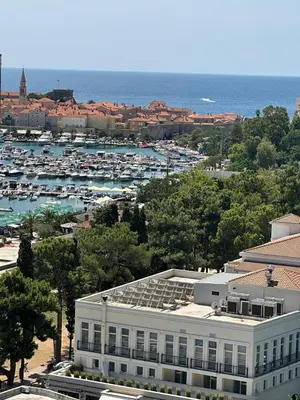 an aerial view of a marina with a large building at Adriatic Dream - Sea View Apartments in Budva