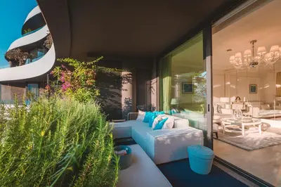 a living room with a blue couch and some plants at Boutique Hotel Vissi d'Arte in Budva