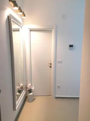 a bathroom with a door and a mirror at Anja apartment_City Center_ in Bar