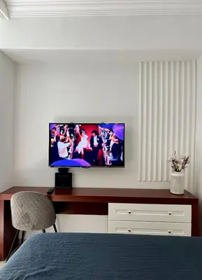 a bedroom with a flat screen tv on a desk at Anja apartment_City Center_ in Bar