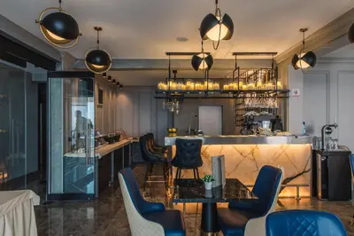 a room with a bar with chairs and a counter at Dollaku Apartments in Bar