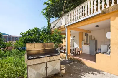 a grill outside of a house with a patio at Apartments Antic in Budva