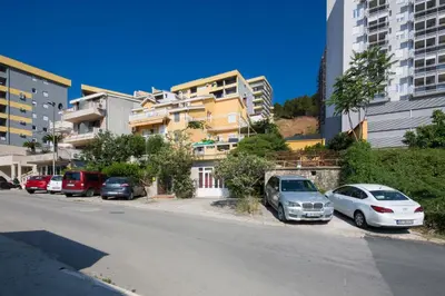 a group of cars parked on the side of a street at Apartments Antic in Budva