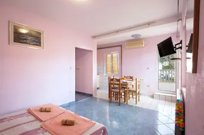 a room with a bed and a table and chairs at Apartments Antic in Budva