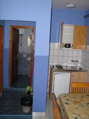 a small kitchen with a sink and a bathroom at Apartments Antic in Budva