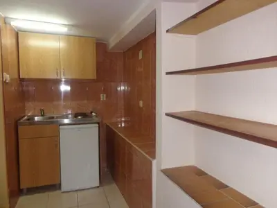 a small kitchen with a sink and a counter at Apartments Antic in Budva