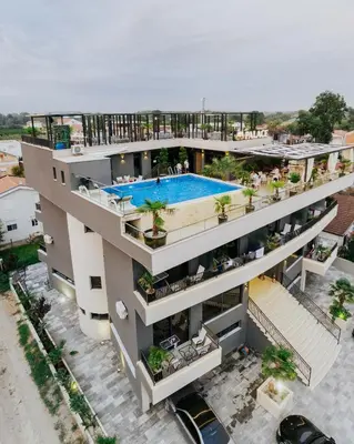 an aerial view of a building with a swimming pool at AM Palace in Ulcinj