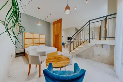 a room with a table and chairs and stairs at AM Palace in Ulcinj