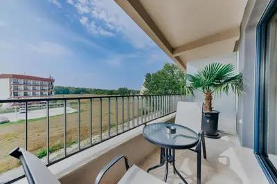 a balcony with a table and chairs and a view at AM Palace in Ulcinj