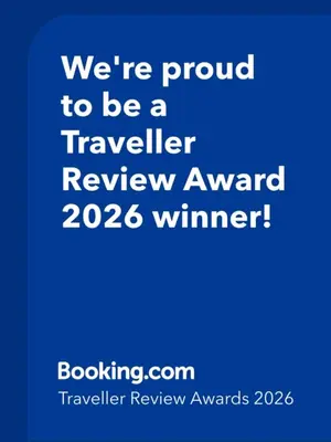 a blue sign that says were proud to be a traveller review award winner at AM Palace in Ulcinj