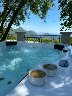 a cup of coffee sitting on a table in a pool at Holiday Home Marija in Budva
