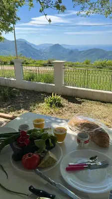 a table with a plate of food on it at Holiday Home Marija in Budva