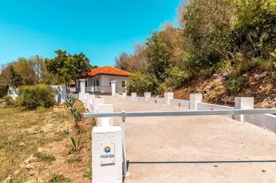 a walkway leading up a hill to a house at Holiday Home Marija in Budva