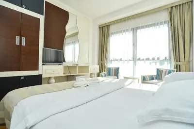 a hotel room with two beds and a television at BARBETA Accommodation in Budva