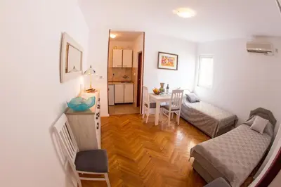 a living room with a bed and a table at Apartments Angela in Budva