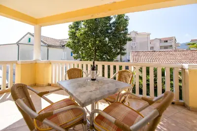 a table and chairs sitting on a balcony at Apartments Angela in Budva
