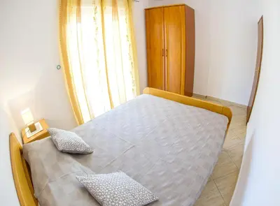 a bed with two pillows on it in a room at Apartments Angela in Budva