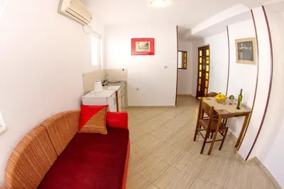 a living room with a couch and a table at Apartments Angela in Budva