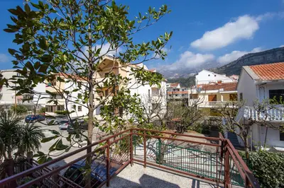 a view from the balcony of a house with a tree at Apartments Angela in Budva