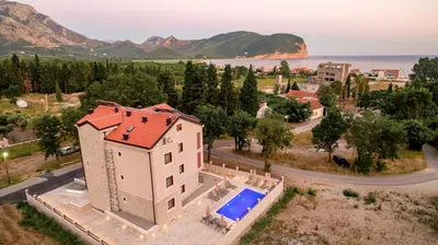 an aerial view of a house with a swimming pool at Luxury Apartments Queen in Petrovac na Moru