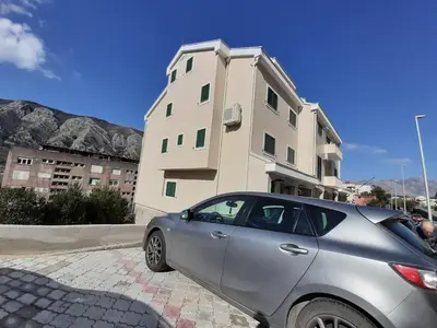 a silver car parked in front of a building at Maritimo di Cattaro****Lux Apartment with Garage in Kotor