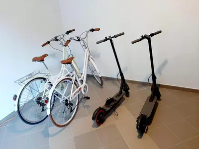 two bikes and scooters are parked in a room at Maritimo di Cattaro****Lux Apartment with Garage in Kotor