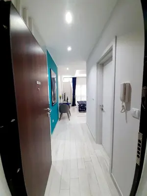 a hallway with a door and a room with a table at Fiore di Cattaro **** Lux Apartment with Parking in Kotor