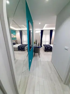 a room with a mirror and two beds and a table at Fiore di Cattaro **** Lux Apartment with Parking in Kotor