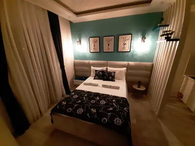 a bedroom with a bed and a green wall at Fiore di Cattaro **** Lux Apartment with Parking in Kotor