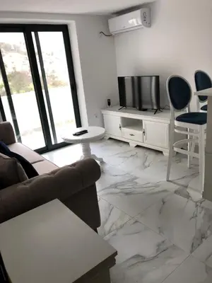 a living room with a couch and a television at Apartment Apollo 2 in Kotor