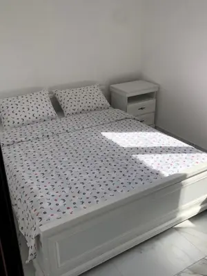 a white bed with polka dots on it in a bedroom at Apartment Apollo 2 in Kotor
