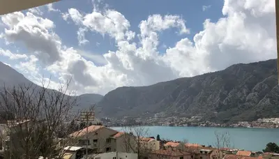 a view of a city and a lake with mountains at Apartment Apollo 2 in Kotor
